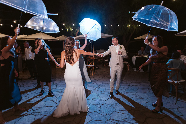 Bride and Groom dancing in the rain.